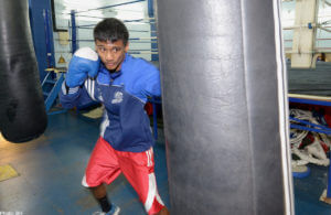 Boxer delivering a powerful punch to a heavy bag.