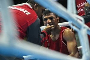 Hanurdeen takes a break in the corner of the ring with his mouthguard being removed.