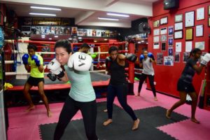 Boxing class participants perfecting their punches.