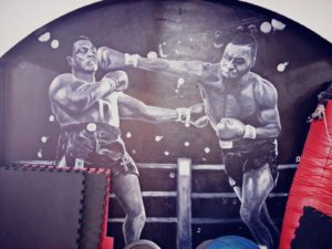 Black and white mural depicting two boxers in an intense fight.