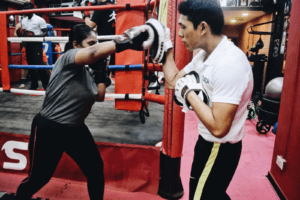 KOS Boxer Receiving Expert Guidance on Punch Techniques