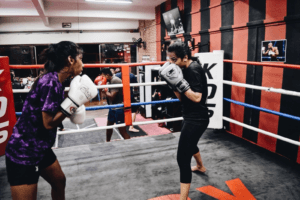 Kickboxing Match: Girls Displaying Technique Over Power