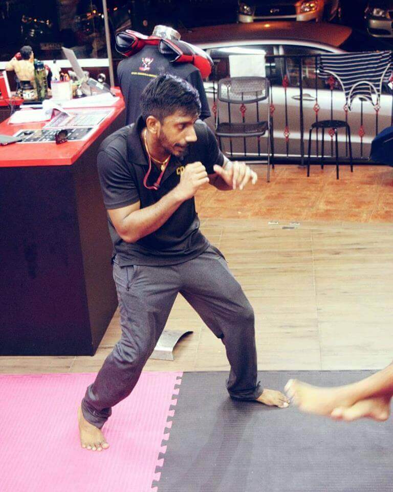 Coach Kumar showcasing proper boxing stance and technique.